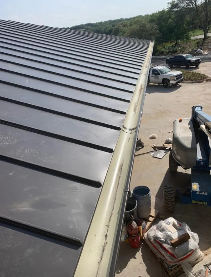 Standing seam panel and gutter detail on a metal roofing jobsite in Casas Adobes